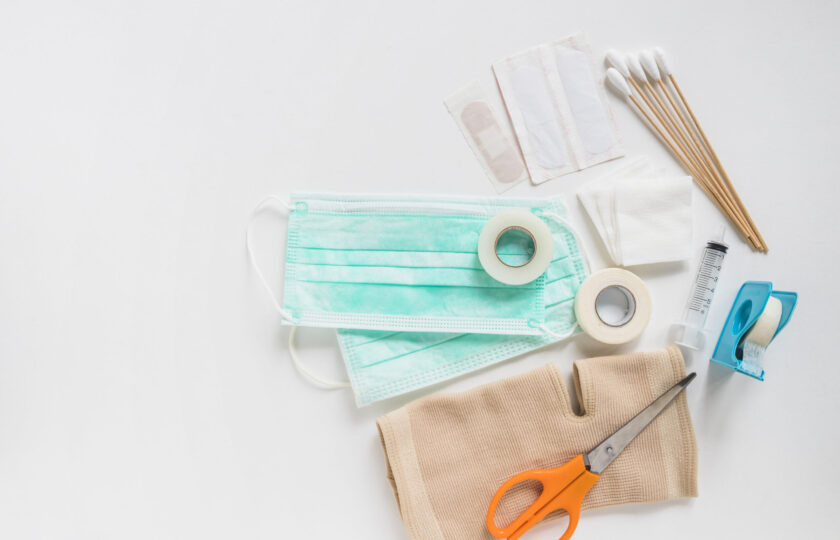 surgical-mask-bandage-gauze-cotton-swabs-sticky-bandage-knee-brace-with-scissor-white-background