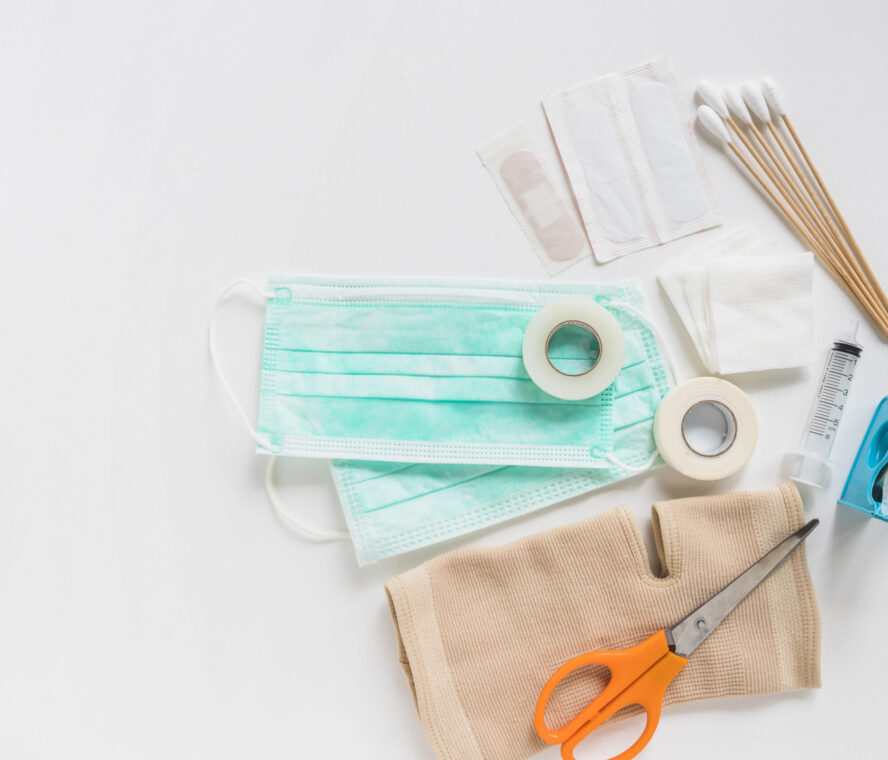 surgical-mask-bandage-gauze-cotton-swabs-sticky-bandage-knee-brace-with-scissor-white-background